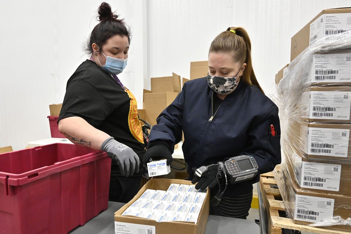 Employees with the McKesson Corporation scan a box of the Johnson & Johnson COVID-19 vaccine while filling an order at their shipping facility in Shepherdsville, Ky., Monday, March 1, 2021. (Timothy D. Easley)