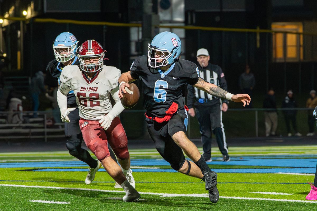 Freeman quarterback Logan Schultz scrambles during a game against Okanogan on Friday at Freeman High School. (Dominic Faagau/For The Spokesman-Review)