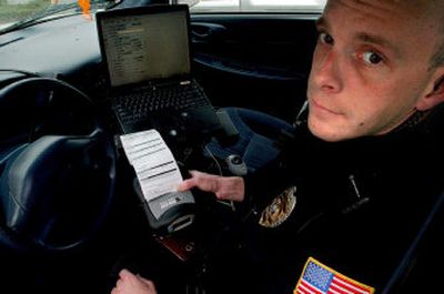 
Post Falls Patrol Officer Patrick Eismann demonstrates e-citations on Wednesday.
 (The Spokesman-Review)