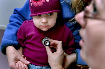 
Marley Burgess, 23 months old,  is examined at the Dirne Community Health Center in Coeur d'Alene by medical assistant Layla Wilson on Wednesday. The United Way funds a large portion of the center. 
 (Kathy Plonka / The Spokesman-Review)