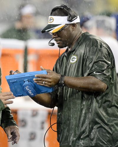 Packers wide receivers coach Edgar Bennett uses a tablet to review game photos. (Associated Press)