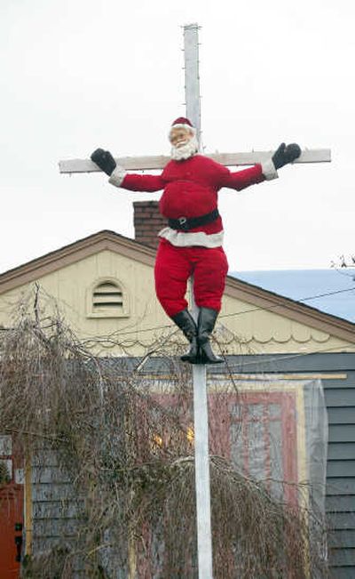 
Art Conrad says the Santa in front of his Bremerton home bemoans the commercialization of Christmas. Associated Press
 (Associated Press / The Spokesman-Review)
