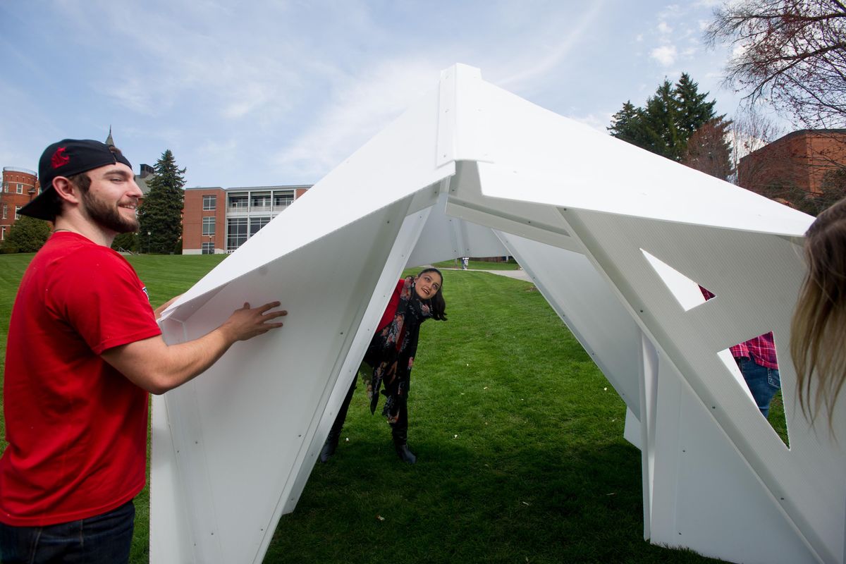 Mona Ghandi a WSU Architecture professor, center helps set up a portable homeless shelter designed her WSU architecture students including Jamie Stidhams, left, on Wednesday, April 19, 2017, in Pullman, Wash. (Tyler Tjomsland / The Spokesman-Review)