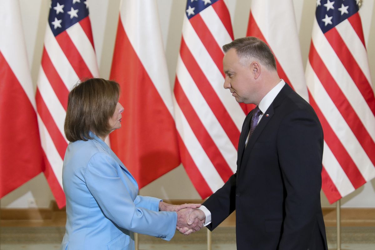 In this photo released by the Office of the President of Poland U.S. Speaker of the House Nancy Pelosi, left, and Poland
