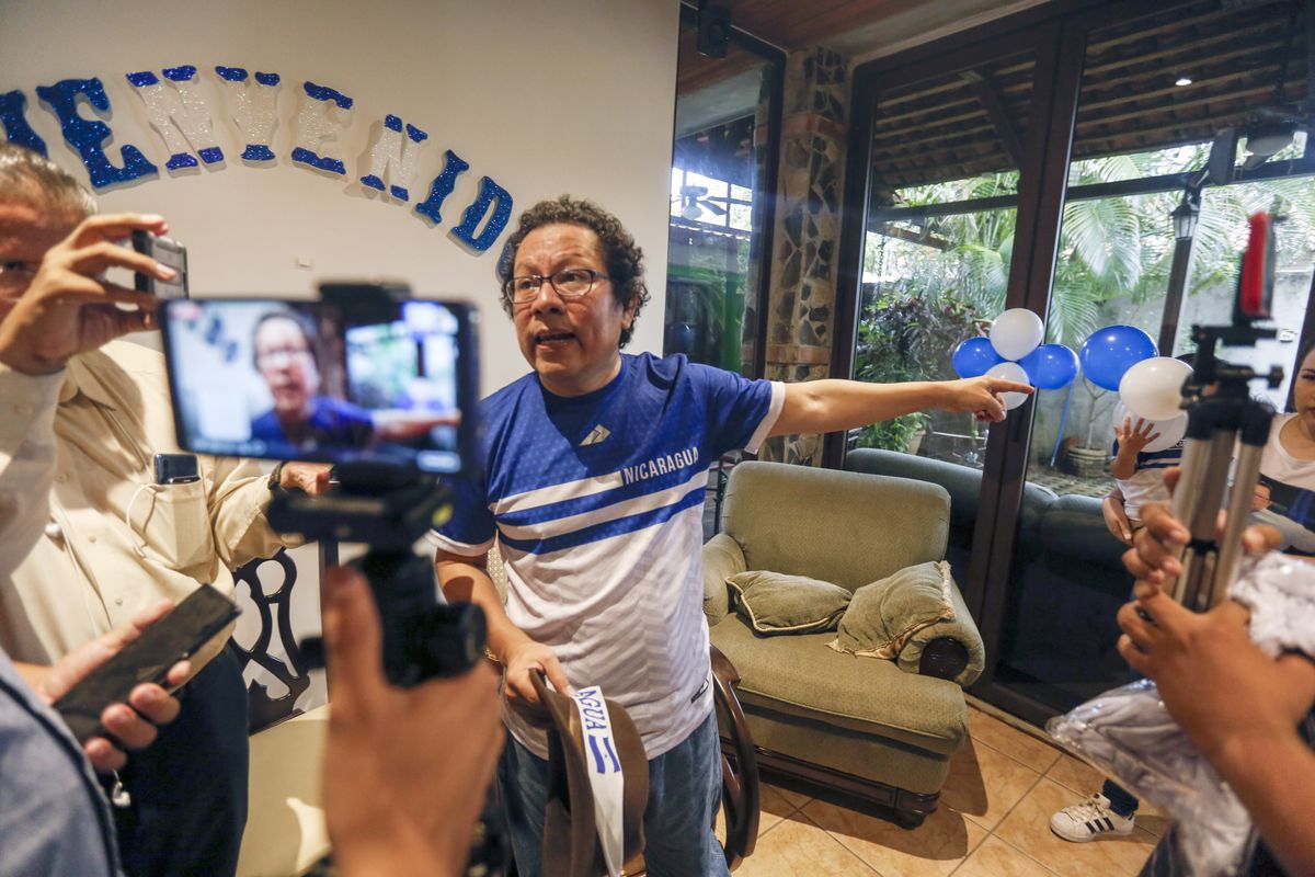 FILE - In this June 11, 2019 file photo, Nicaraguan journalist Miguel Mora speaks to the press after his release from prison, at his home in Managua, Nicaragua, amid a broader move to set free people the opposition considers political prisoners under an agreement meant to ease the country