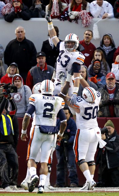 Auburn tight end Philip Lutzenkirchen (43) celebrates with offensive lineman Ryan Pugh (50) and quarterback Cameron Newton (2) after scoring the final touchdown in Auburn’s come-from- behind victory over Alabama on Friday. (Associated Press)