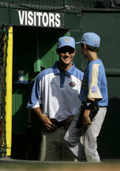 
Chandler Ariz., coach Clay Bellinger, left, smiles at his son and Arizona player Cody Bellinger as they come into the dugout in the third inning Saturday. Associated Press
 (Associated Press / The Spokesman-Review)