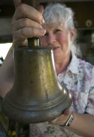 
Wanda Woodbury shows off a ship's bell. The retired teacher has been collecting  bells since 1960.
 (Photos by Christopher Anderson/ / The Spokesman-Review)
