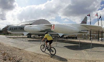 
A bicyclist rides past the centerpiece of the Lowry Air Force Base development near Denver. 
 (Associated Press / The Spokesman-Review)