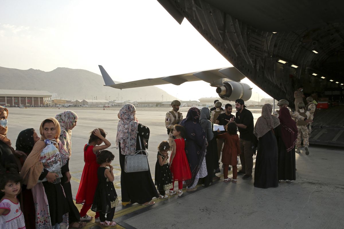 Afghans prepare to to be evacuated aboard a Qatari transport plane, at Hamid Karzai International Airport in Kabul, Afghanistan, August, 18, 2021. Qatar played an out-sized role in U.S. efforts to evacuate tens of thousands of people from Afghanistan. Now the tiny Gulf Arab state is being asked to help shape what is next for Afghanistan because of its ties with both Washington and the Taliban insurgents now in charge in Kabul.  (HOGP)