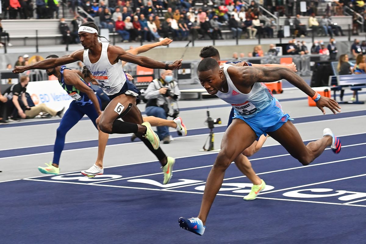 Grant Holloway, right, crosses the finish line to win the men’s 60-meter hurdles with a time of 7:07 during the 2022 USAFT Indoor Championships on Feb. 27 at the Podium in Spokane.  (COLIN MULVANY/THE SPOKESMAN-REVIEW)