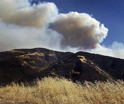 
A large plume from the School Fire rises over the burnt Blue Mountains last month. 
 (Jed Conklin / The Spokesman-Review)