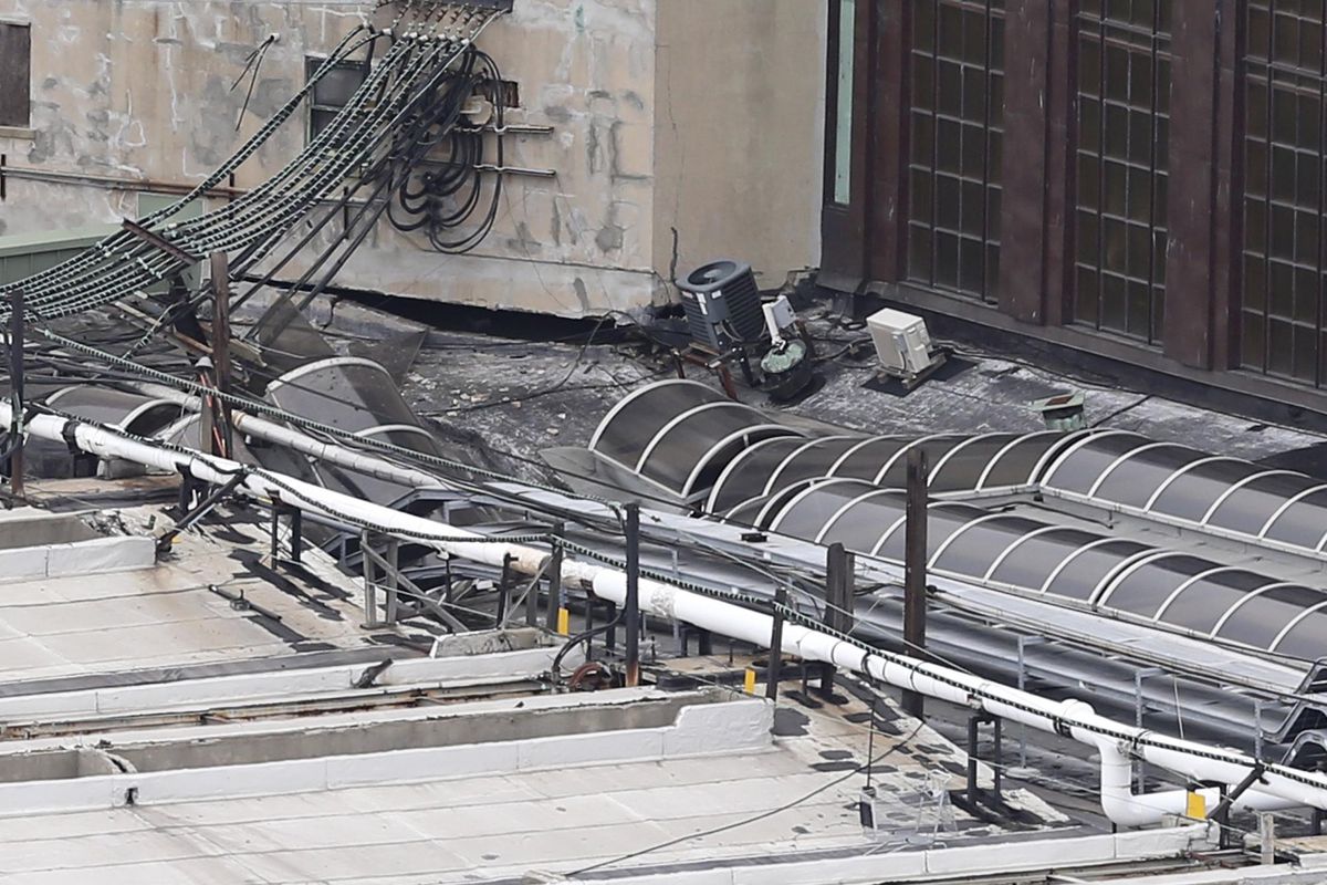 Damage is seen on a section of the roof of the Hoboken station as seen from Jersey City, N.J., Thursday, Sept. 29, 2016. A crowded commuter train plowed into the bustling station during the morning rush hour Thursday, injuring more than 100 in a tangle of broken concrete, twisted metal and dangling cables, authorities said. (Seth Wenig / Associated Press)