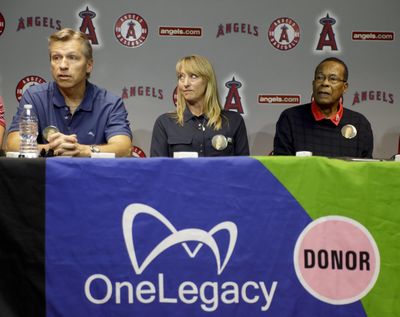 Baseball Hall of Famer and transplant recipient Rod Carew, right, looks on with Mary Reuland as her husband, Ralf, talks about their sons donation during a news conference in Anaheim, Calif., Tuesday, April 25, 2017. Carew received a heart and kidney donation from Konrad Reuland that gave Carew a second chance at life. (Chris Carlson / Associated Press)