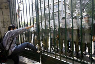 
A student kicks a gate at Tehran University during Monday's protest against President Mahmoud Ahmadinejad.Associated Press
 (Associated Press / The Spokesman-Review)
