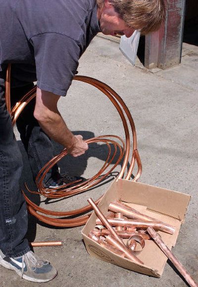 
Chris Jacobson at Clark's Valley Recycling Center in Spokane Valley displays the kind of copper pipes that thieves have been targeting. Modern Electric, Avista, Union Pacific and Inland Power and Light have all been victims of copper theft recently. 
 (Liz Kishimoto / The Spokesman-Review)