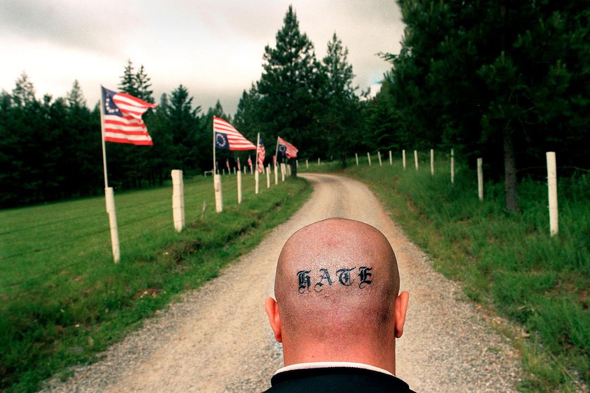 An Aryan Nation supporter walks to the former site of the white supremacist group’s compound near Hayden Lake in December 2001. (Brian Plonka / The Spokesman-Review)