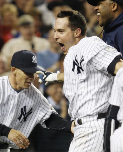 Mark Teixeira celebrates his winning homer in the 11th.  (Associated Press / The Spokesman-Review)