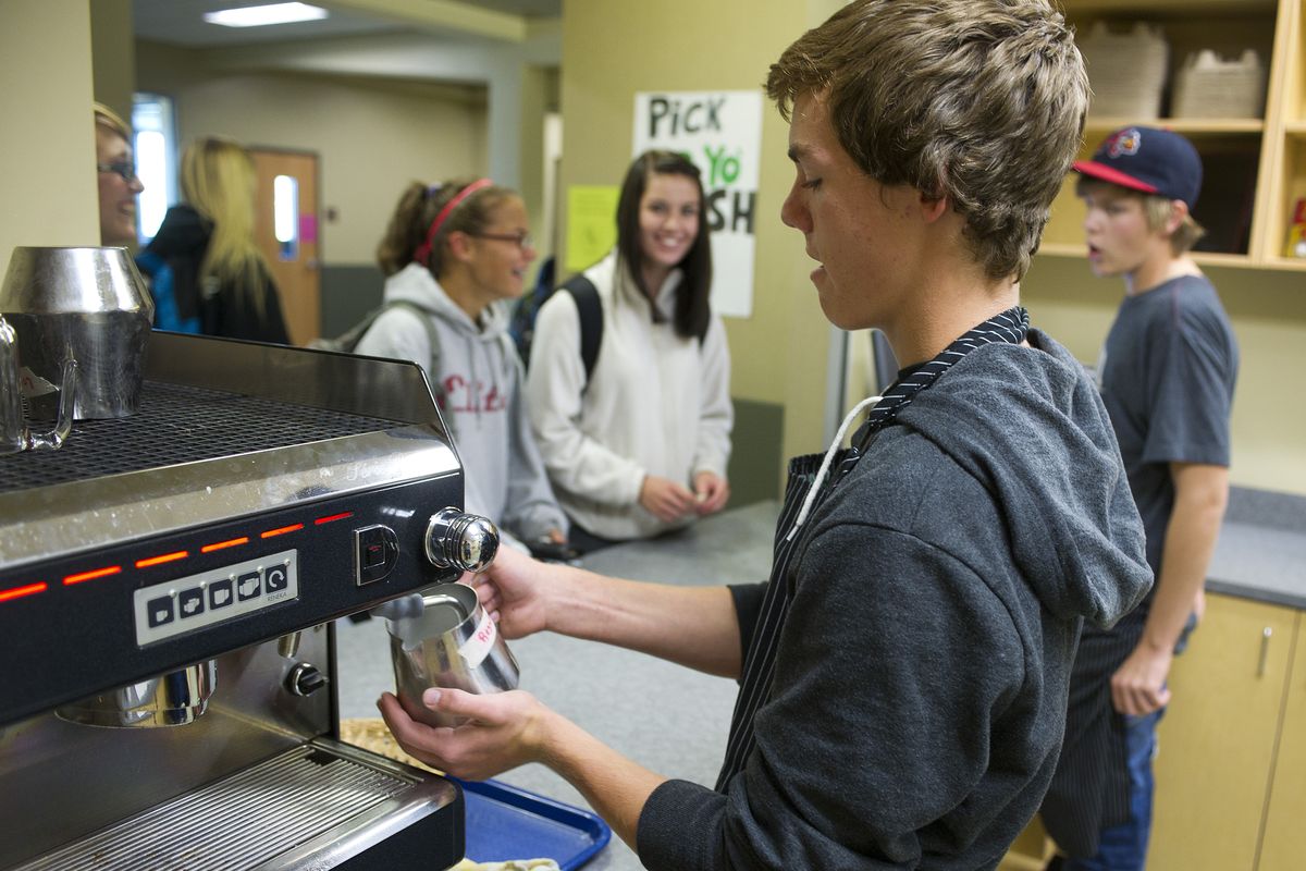 At the Bagpipers Bistro coffee shop in Shadle Park High School on Wednesday, Cody Doggett, 15, makes a mocha latte for a student. (Colin Mulvany)