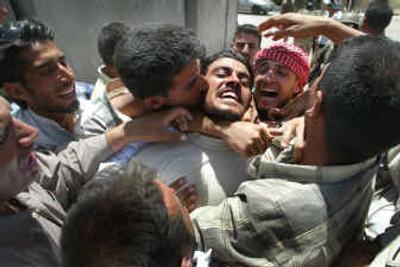 
An Iraqi man is surrounded by family members and friends as he is released from Baghdad's Abu Ghraib prison Monday. Hundreds of prisoners were freed. 
 (Associated Press / The Spokesman-Review)