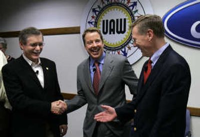 
United Auto Workers president Ron Gettelfinger, left, Ford Motor Co. executive chairman Bill Ford, center, and Ford Motor Co. president and CEO Alan Mulally shake hands after signing the automaker's new 4-year contract. Associated Press
 (Associated Press / The Spokesman-Review)