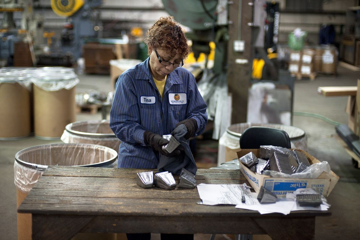 Tina Veira cleans bells in a temporary site of the Bevin Bros. manufacturing in East Hampton, Conn., Wednesday, Oct. 3, 2012. The 180-year-old New England company that made the tiny bell that tinkles every time an angel gets its wings in the holiday classic "It