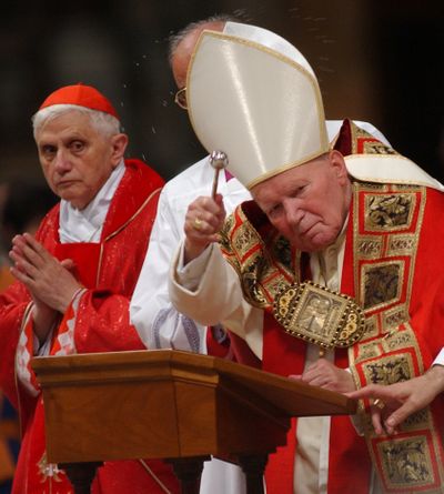 Cardinal Joseph Ratzinger, left, who later became Pope Benedict XVI, is seen with Pope John Paul II during Mass in St. Peter’s Basilica in 2002.  (Associated Press)