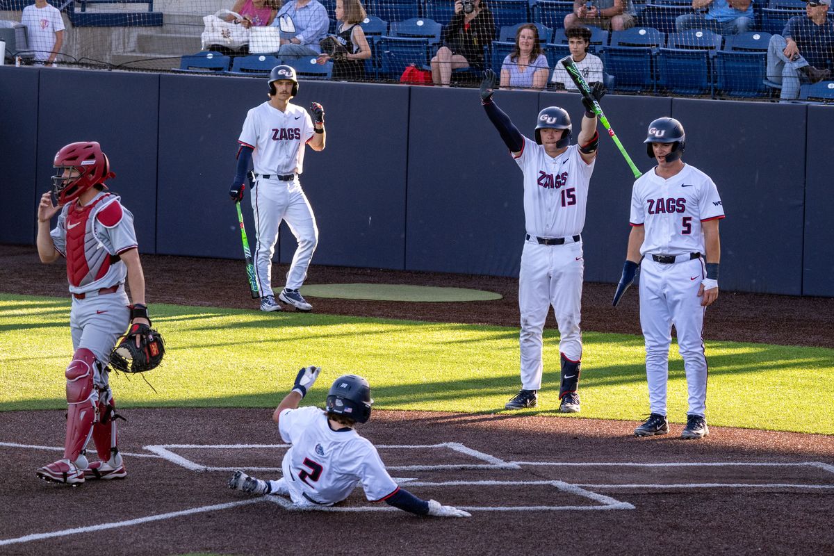 Gonzaga’s Ryder Young slides safely into home after a two-run RBI single from Maddox Haley in the bottom of the sixth inning on Monday at Gonzaga University. Mikey Bell, right, also scored.  (Colin Mulvany/The Spokesman-Revi)