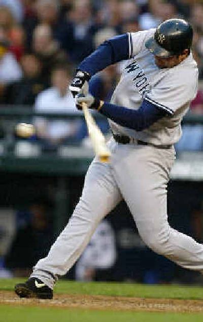 Yankees' Jason Giambi hits an RBI single during the fourth inning against the Mariners in Seattle.
(Associated Press / The Spokesman-Review)