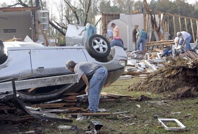 Volunteers help clean up a home destroyed by a tornado in Kenly, N.C., on Saturday, after severe weather moved through the area, killing at least two people.  (Associated Press / The Spokesman-Review)