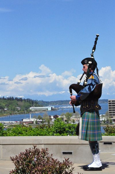 Washington State Patrol Lt. Keith Huntley plays the bagpipes at the Washington State Law Enforcement Memorial before the service  on the Capitol campus Friday.  (Jim Camden)