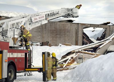 Spokane firefighters check a warehouse at Interior Solutions, 2812 N. Pittsburgh St., after the roof collapsed Friday.  (CHRISTOPHER ANDERSON / The Spokesman-Review)