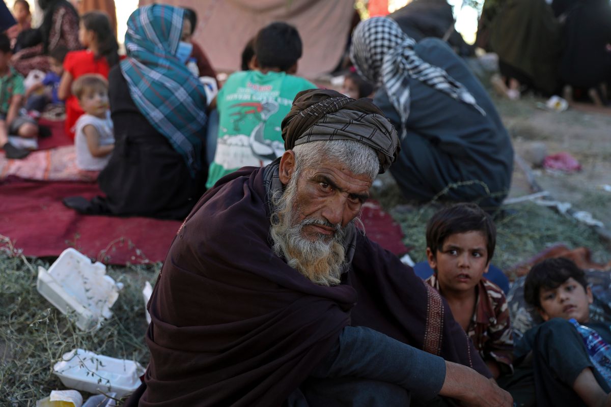 FILE- Internally displaced Afghans from northern provinces, who fled their home due to fighting between the Taliban and Afghan security personnel, take refuge in a public park in Kabul, Afghanistan, Monday, Aug. 9, 2021. Afghanistan is the unhappiest country in the world — even before the Taliban swept to power last August. That