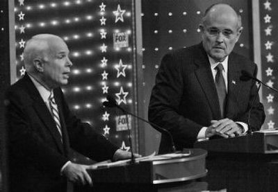 
Republican presidential hopeful Sen. John McCain, R-Ariz., makes comments about the Iraq war as former New York Mayor Rudy Giuliani watches during Tuesday night's GOP debate. 
 (Associated Press / The Spokesman-Review)