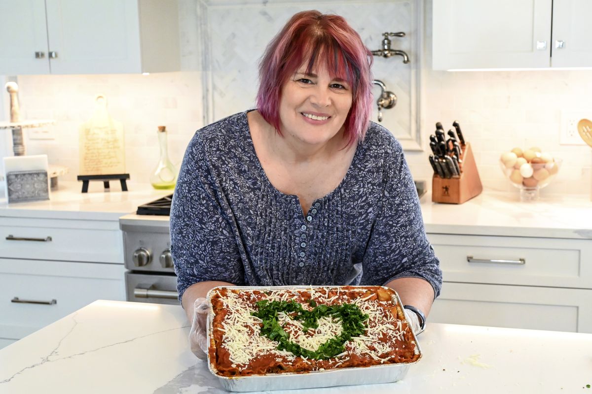 Shari DiBrito, the New Jersey regional director for the nonprofit Lasagna Love, holds a lasagna on May 1 at her niece’s house in Wayne, N.J. Below right: DiBrito is seen making a lasagna. The grassroots nonprofit organization offering Americans free lasagnas recently surpassed its 100,000 lasagna delivery mark. Lasagna Love has been sharing the meals with Americans struggling with financial and other challenges brought on by the COVID-19 pandemic.  (HONS)