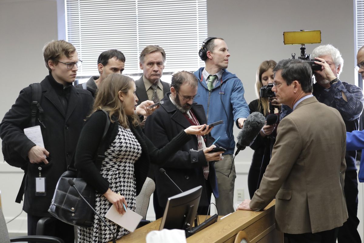 Reporters talk with Sen. Mark Miloscia, R-Federal Way, third from right, following a joint work session of the Senate and House State Government Committees, Thursday, Feb. 22, 2018, at the Capitol in Olympia, Wash. The session was held to discuss a bill filed Wednesday by lawmakers who want to circumvent a recent court ruling finding them fully subject to the state