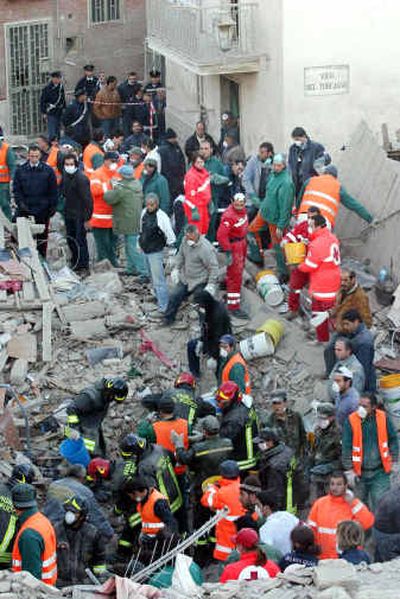 
Rescuers look for survivors after a two-story building was destroyed in an explosion Saturday in Foggia, southern Italy.
 (Associated Press / The Spokesman-Review)