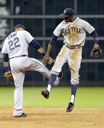 Seattle Mariners Robinson Cano (22) and James Jones celebrate their 10-4 win over the Houston Astros in a baseball game Monday in Houston. (Associated Press)