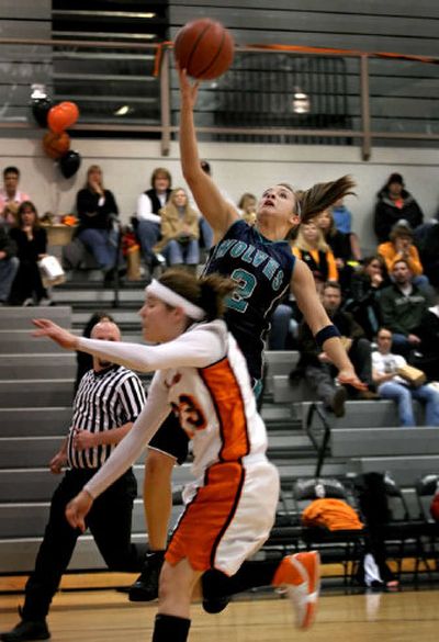 
Lake City's Richelle Fenenbock  finishes a fastbreak with a layup over Post Falls' Jordan Schoening during the first quarter Friday night.
 (BRUCE TWITCHELL Special to / The Spokesman-Review)