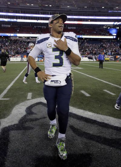 Seattle sports fans are always willing to coalesce around Seahawks quarterback Russell Wilson. (Steven Senne / Associated Press)