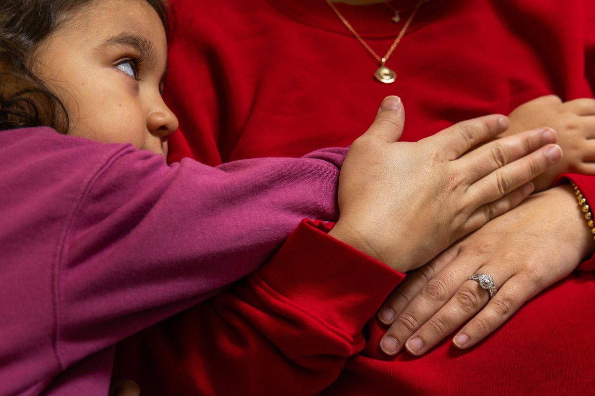 Vivian Sullaway leans on her pregnant mother, Chelsey Sullaway, before a medical appointment in Hondo, Texas. Sullaway, who voted red in the last election, has said her vote may change if her access to health care is impacted by potential Republican Medicaid cuts. MUST CREDIT: Kaylee Greenlee/For The Washington Post (Kaylee Greenlee/for The Washington Post)