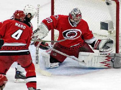 
Cam Ward blocks a shot from Chris Drury (behind Aaron Ward, 4). 
 (Associated Press / The Spokesman-Review)