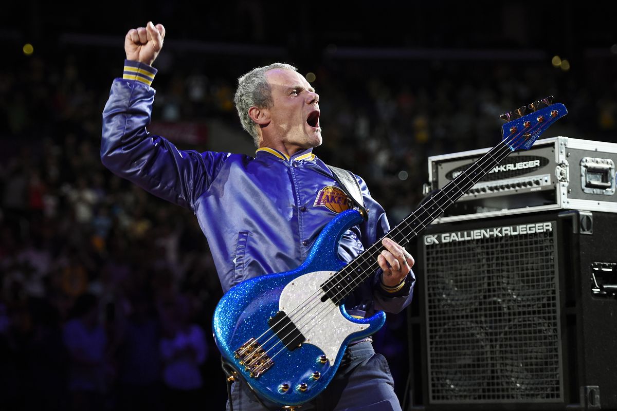 In this April 13, 2014 photo, Flea, bassist for the Red Hot Chili Peppers, plays the national anthem prior to an NBA basketball game between the Los Angeles Lakers and the Memphis Grizzlies in Los Angeles. Flea turned 59 on Saturday, Oct. 16, 2021, and his Silverlake Conservatory of Music turned 20, and they celebrated with a joint party in the parking lot for the Los Angeles school that often serves as a de facto performance space for its faculty and students.  (Mark J. Terrill)