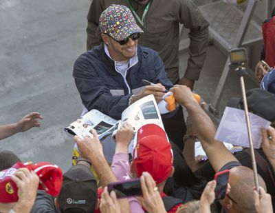 Mercedes driver Lewis Hamilton, of Great Britain, signs autographs during the open house day for the Formula One Canadian Grand Prix auto race in Montreal, Thursday, June 6, 2019. (Ryan Remiorz / Canadian Press via AP)