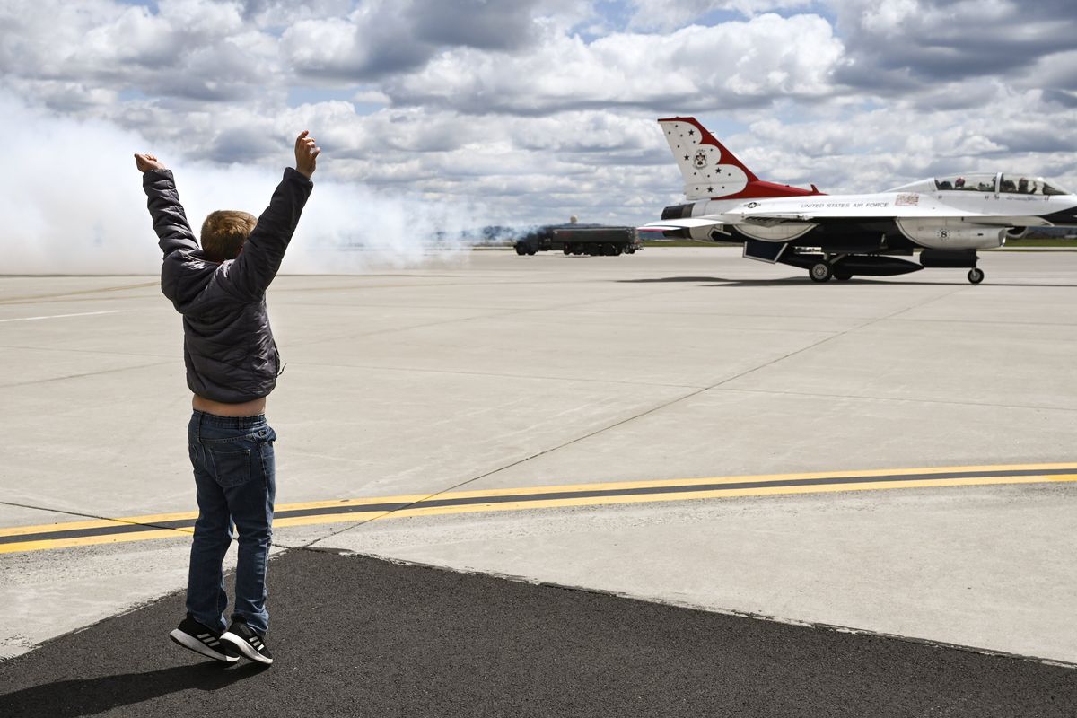 Landon Carbaugh, 9, cheers Friday as his father Patrick Ray Carbaugh was taken for a thrilling ride in a U.S. Air Force Thunderbirds F-16 fighter jet at Fairchild Air Force Base.  (COLIN MULVANY/THE SPOKESMAN-REVIEW)
