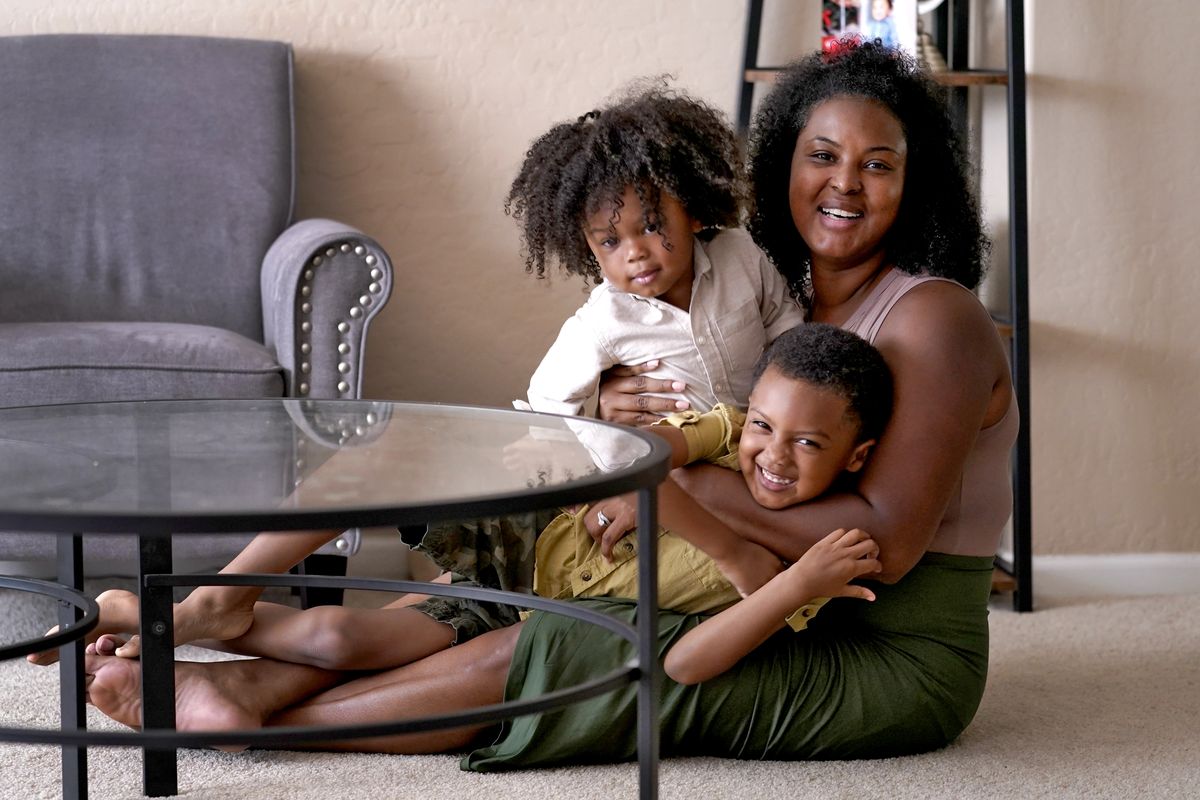 Kisha Gulley appears with her sons Sebastian, 2, left, and Santana, 5, on Sept. 3 in Phoenix. Gulley is an Instagram influencer and blogger who generates income from her content.  (Matt York)