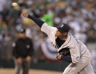 Seattle Mariners' Felix Hernandez pitched the distance in the Mariners' 6-2 victory over Oakland in a season opener.  (Ben Margot / Associated Press)
