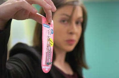 
WashPIRG's Robin Engle displays a toy with too much lead Tuesday in Spokane. 
 (CHRISTOPHER ANDERSON / The Spokesman-Review)