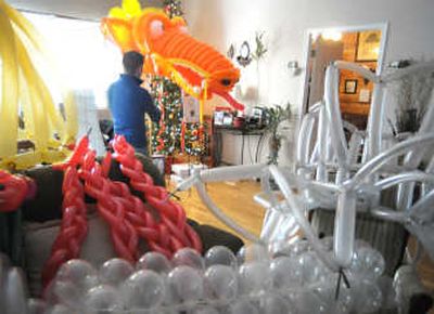 
Balloon artist Ryan Oelrich works on his Chinese luck dragon in his home on Sunday. He is creating the dragon, a dancer and a French horn the size of a car for First Night activities. 
 (Photos by Christopher Anderson / The Spokesman-Review)