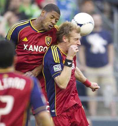 Real Salt Lake's Chris Schuler, left, collides with teammate Nat Borchers while going up for a header during the first half of play in a MLS soccer match.  Salt Lake beat the host Seattle Souders 1-0. (Associated Press)